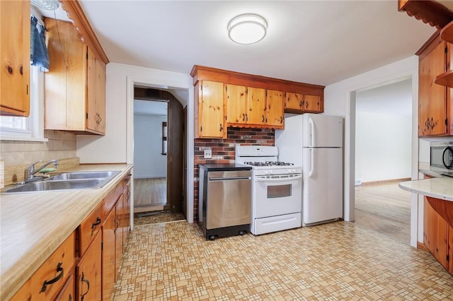 kitchen with sink, white appliances, and backsplash