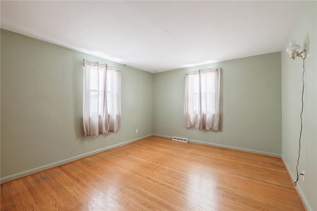 unfurnished room with light hardwood / wood-style floors