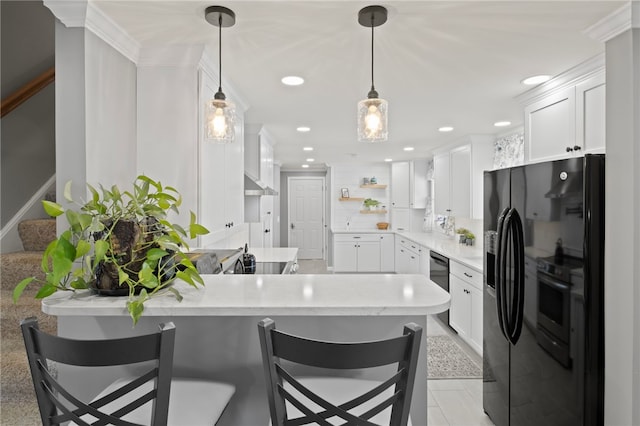 kitchen with white cabinetry, hanging light fixtures, kitchen peninsula, and a kitchen breakfast bar