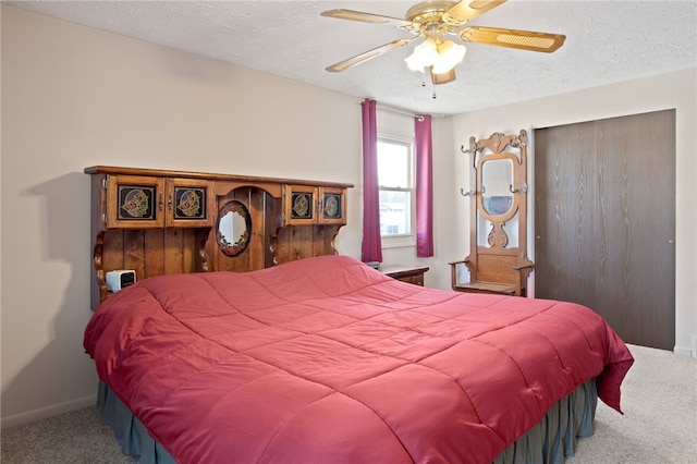 bedroom featuring ceiling fan, carpet flooring, and a textured ceiling