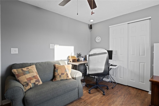 home office with dark wood-type flooring and ceiling fan