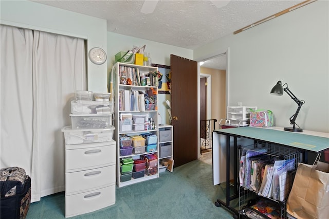 office with dark colored carpet and a textured ceiling