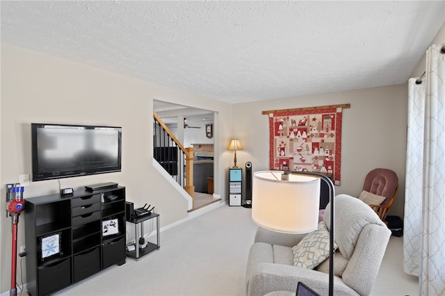 carpeted living room with a textured ceiling