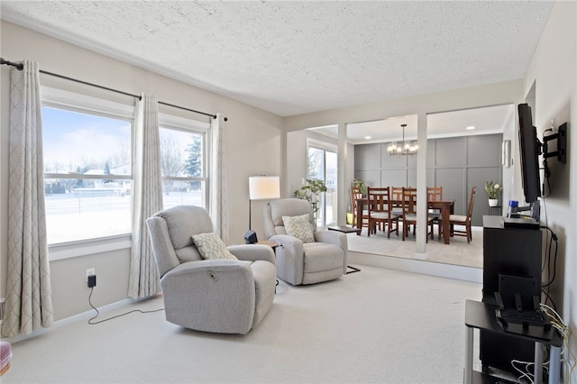 carpeted living room featuring a textured ceiling and a notable chandelier