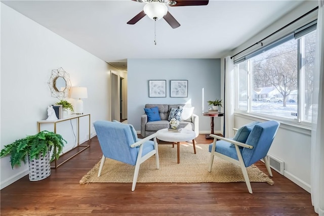 sitting room with dark hardwood / wood-style floors and ceiling fan