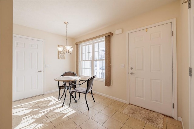 tiled dining room featuring a chandelier