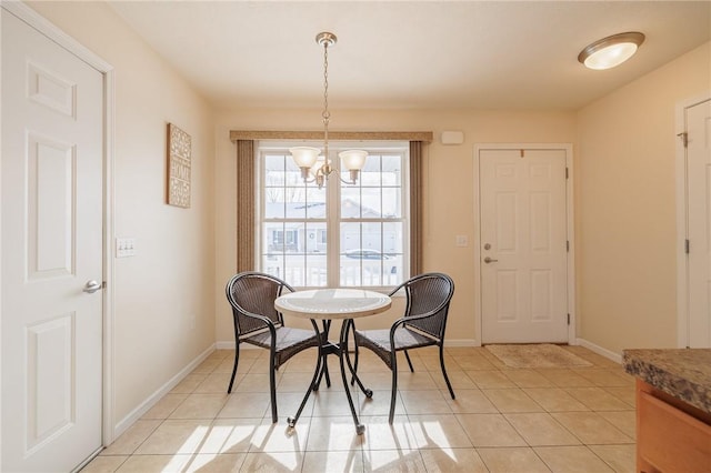 tiled dining room featuring a chandelier