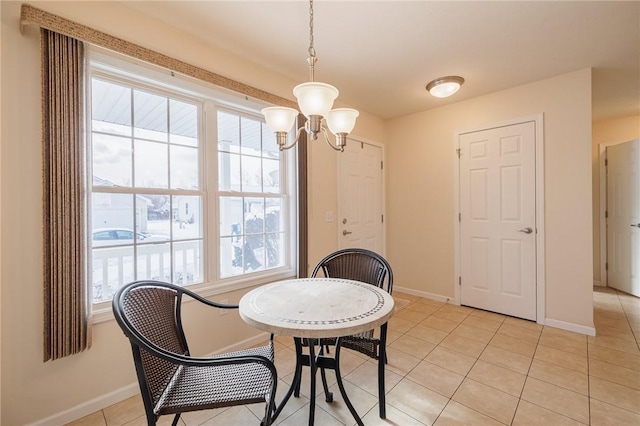 dining room featuring light tile patterned floors and a chandelier