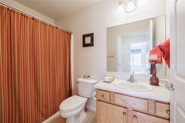 bathroom featuring vanity, toilet, and tile patterned flooring