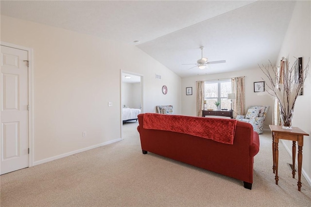 carpeted living room with ceiling fan and lofted ceiling