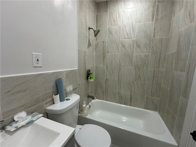 full bathroom featuring sink, tile walls, toilet, and tiled shower / bath combo