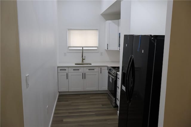 kitchen with sink, black appliances, white cabinets, and dark hardwood / wood-style flooring