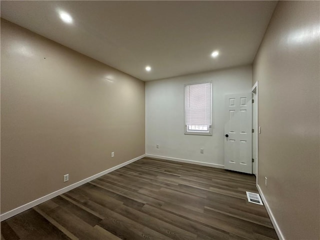 empty room with dark wood-type flooring