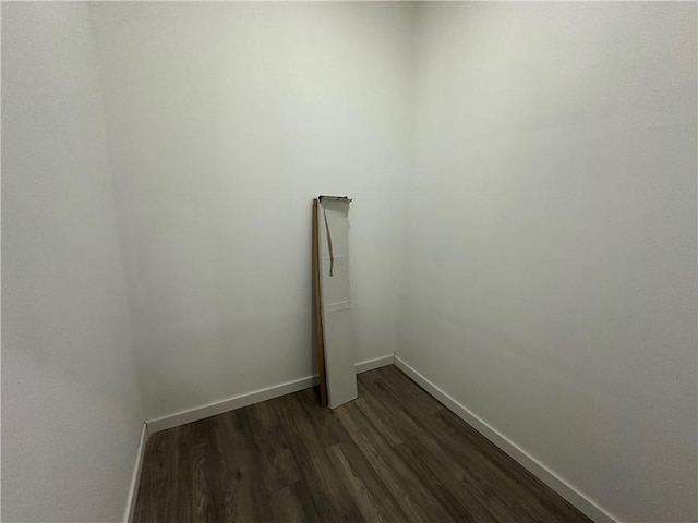 unfurnished room with dark hardwood / wood-style flooring