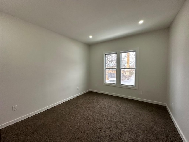 empty room featuring dark colored carpet