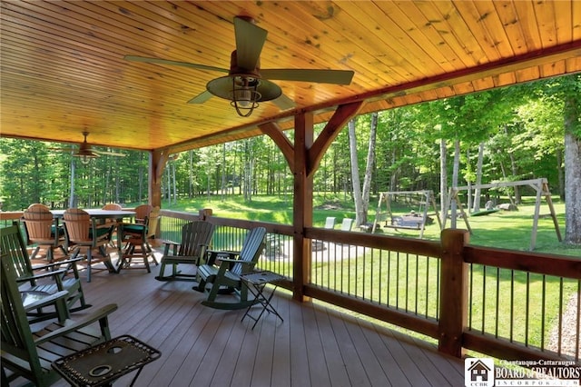 wooden deck with a yard and ceiling fan