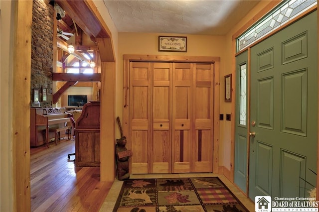 foyer featuring hardwood / wood-style floors, plenty of natural light, and a textured ceiling