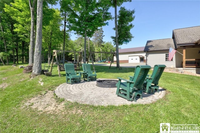 exterior space with an outdoor fire pit, a patio, and a playground