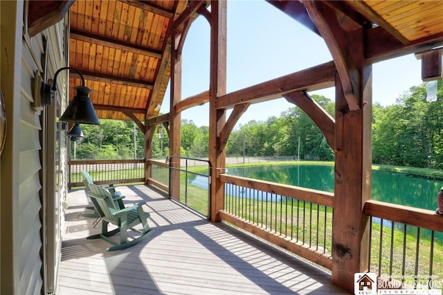 wooden terrace featuring a water view