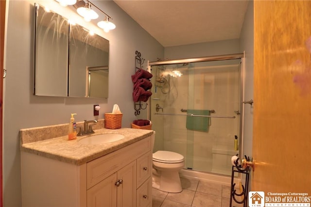 bathroom with a shower with door, toilet, tile patterned floors, and vanity