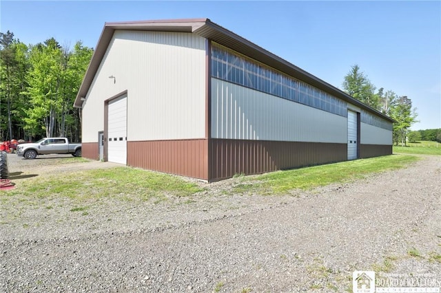 view of property exterior featuring a garage and an outbuilding