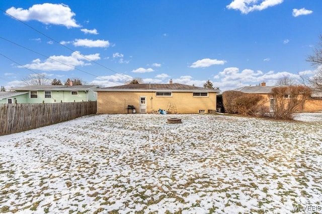 view of snow covered rear of property