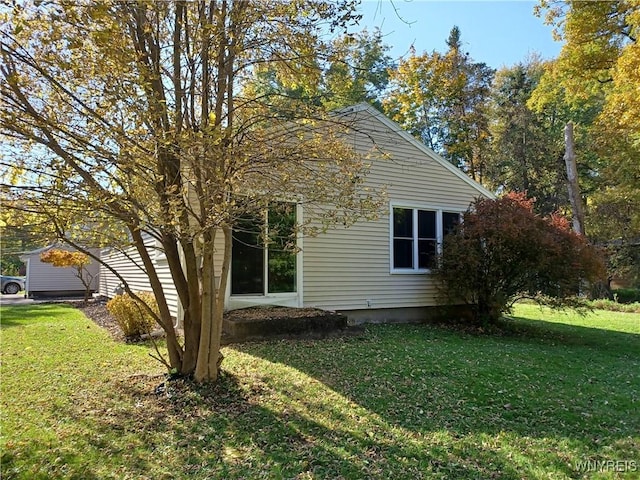 view of side of home with a lawn