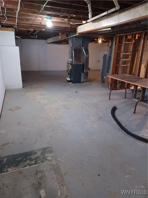 basement featuring heating unit and water heater