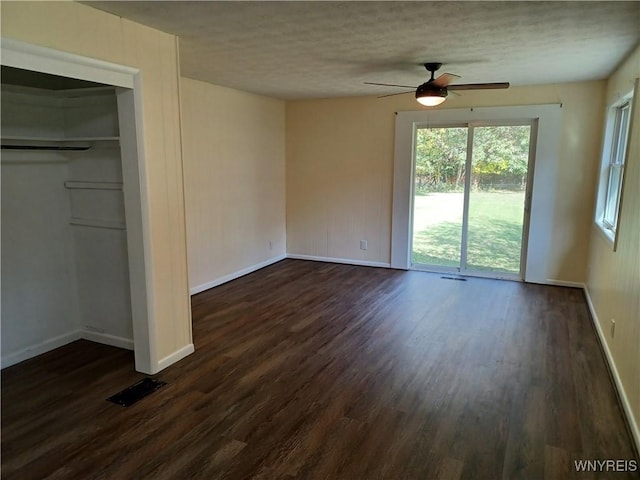 unfurnished bedroom featuring a closet, ceiling fan, and dark hardwood / wood-style flooring