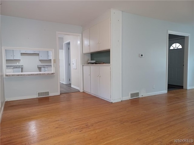 unfurnished living room featuring light hardwood / wood-style floors