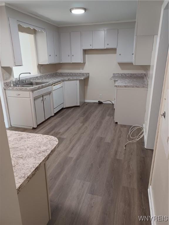 kitchen with white dishwasher, sink, white cabinetry, ornamental molding, and light hardwood / wood-style floors