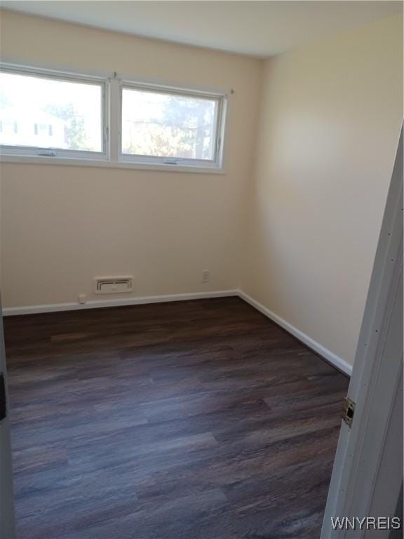 unfurnished room featuring dark hardwood / wood-style floors