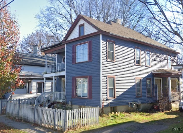 view of side of property featuring a balcony