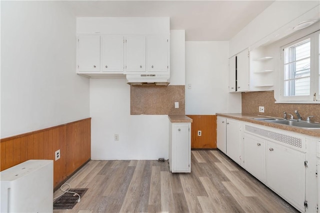 kitchen featuring sink, white cabinets, and light wood-type flooring