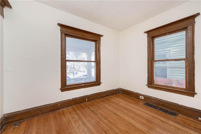 spare room with wood-type flooring