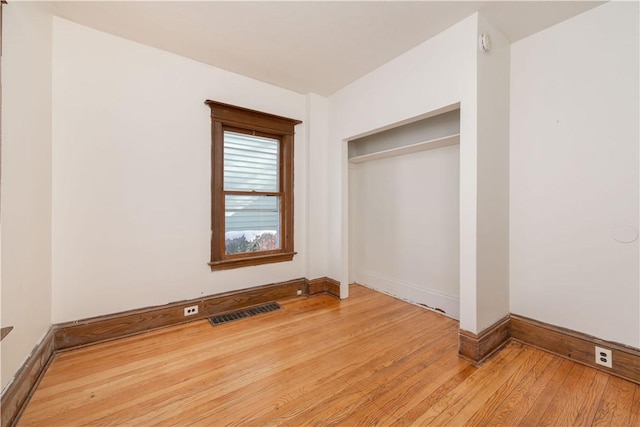 unfurnished bedroom with light hardwood / wood-style floors and a closet