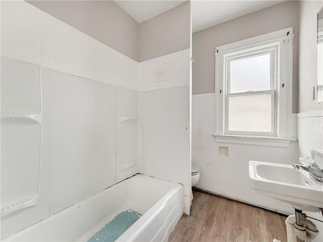 bathroom with toilet and hardwood / wood-style flooring