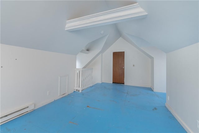 additional living space featuring baseboard heating and vaulted ceiling