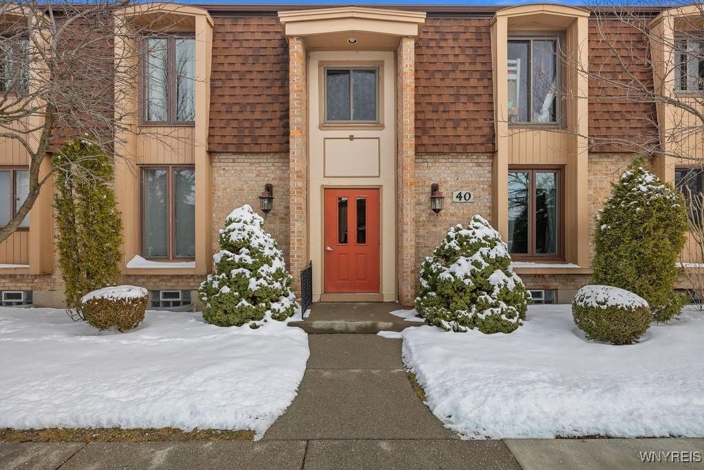 view of snow covered property entrance