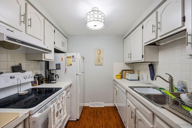 kitchen featuring white appliances, white cabinets, dark hardwood / wood-style flooring, sink, and backsplash