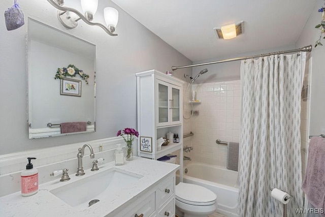 full bathroom with a chandelier, toilet, shower / tub combo, and vanity