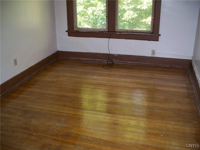 unfurnished room featuring dark hardwood / wood-style flooring