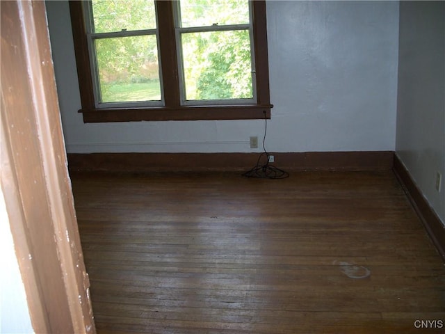 spare room with dark hardwood / wood-style floors