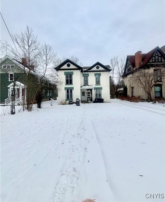 view of snow covered rear of property