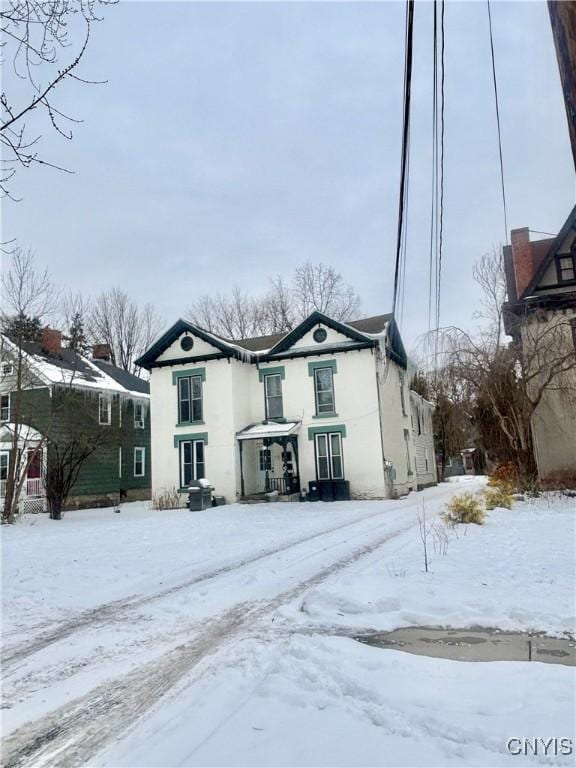 view of snow covered back of property