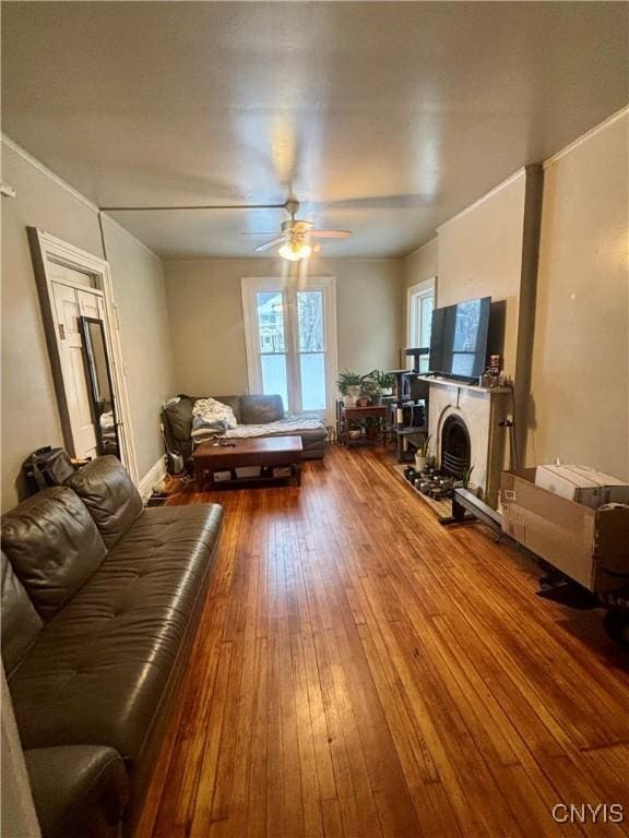 living room featuring hardwood / wood-style floors and ceiling fan