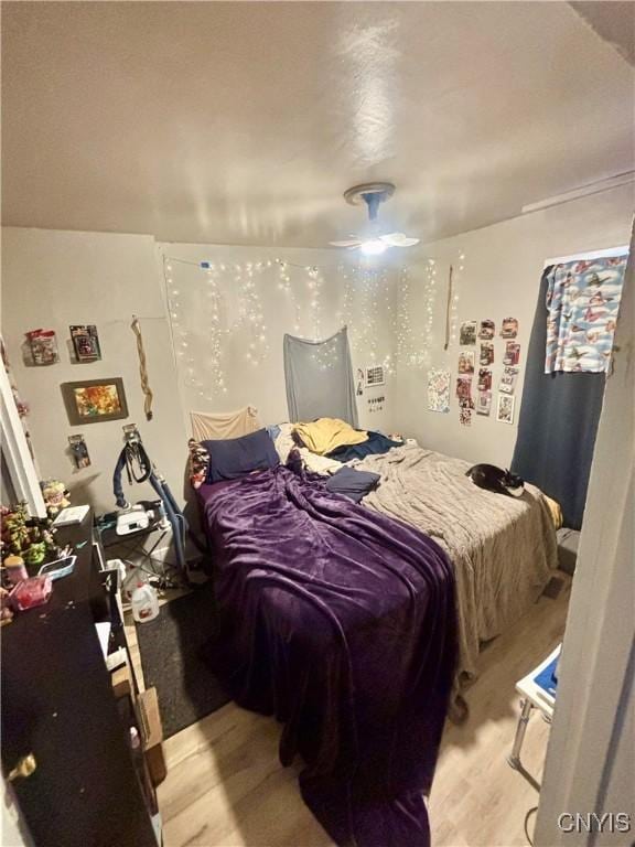 bedroom featuring ceiling fan and light hardwood / wood-style flooring