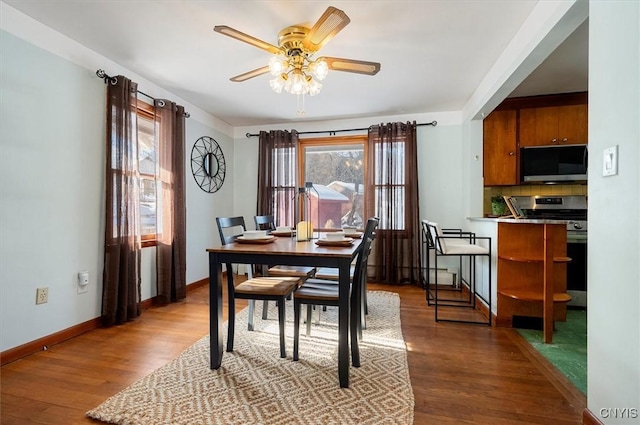 dining space featuring hardwood / wood-style flooring and ceiling fan