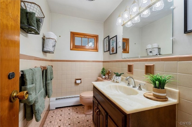 bathroom with vanity, toilet, tile walls, and a baseboard radiator