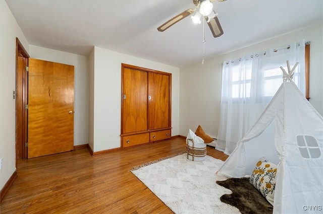 bedroom featuring a closet, ceiling fan, and light wood-type flooring